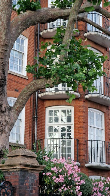 A close-up view of a brick wall featuring a rectangular metal street sign that reads 'LOWER TERRACE NW3' mounted on the dark red bricks. The sign's background is painted with alternating green and whi